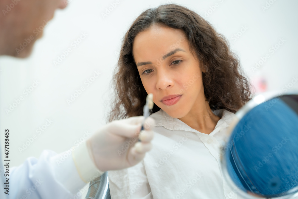 Dentist using dental equipment for examination of teeth of a female patient,Compare teeth with sampler in dentistry. Dentist using dental equipment for examination of teeth of a female patient,Compare teeth with sampler in dentistry.