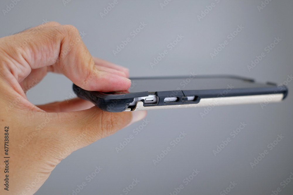 Photo of hand holding smartphone with broken phone case. Cracking smartphone case. Damaged phone case. Photo of hand holding smartphone with broken phone case. Cracking smartphone case. Damaged phone case.
