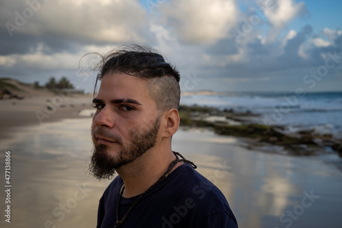 White male between 25 and 30 years old with a modern haircut and suspicious attitude