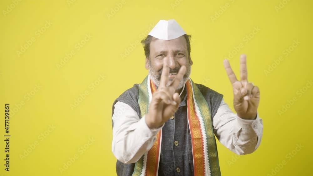 happy smiling Politician showing victory or v sign gesture to audience - concept of Poll victory, positive or confidence about election results and win or successful celebration. happy smiling Politician showing victory or v sign gesture to audience - concept of Poll victory, positive or confidence about election results and win or successful celebration.