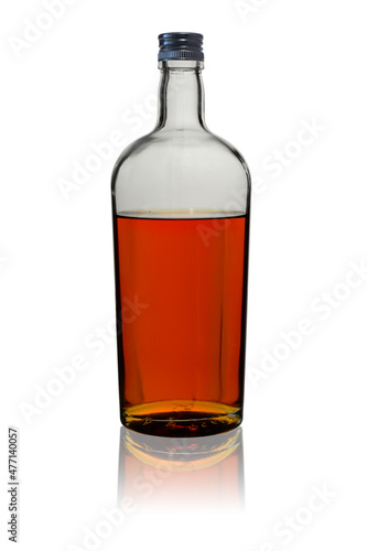 Transparent glass bottle filled with aged brown alcoholic beverage. Isolated on a white background  covered with a lid with reflection