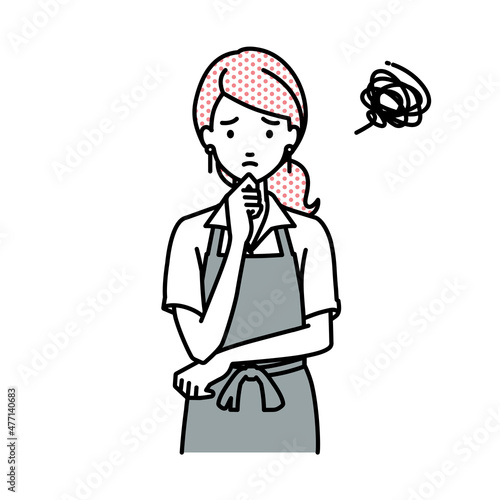 立って手をあごにあてて困っているカフェ店員の女性