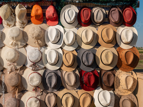 Bright colored hats for men and women are on sale.