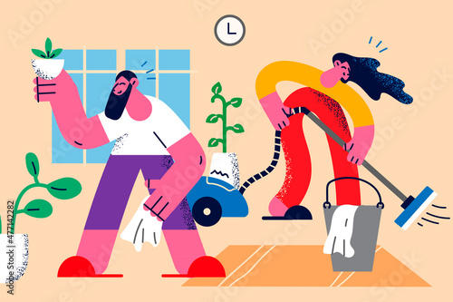 Happy couple do household chores together 