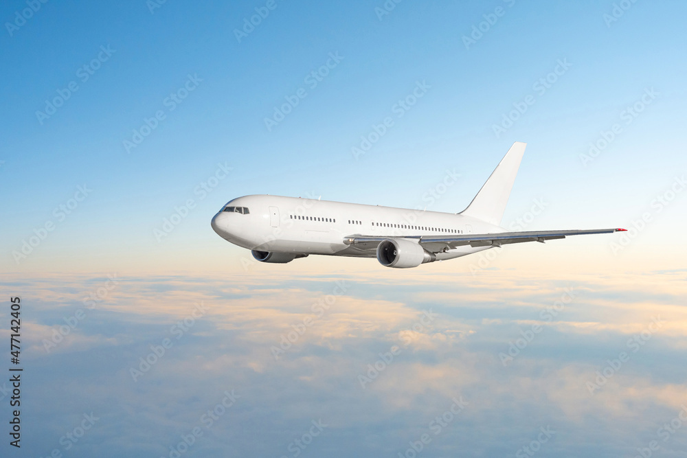 Fototapeta premium Evening flight flying plane in the sky before sunset.