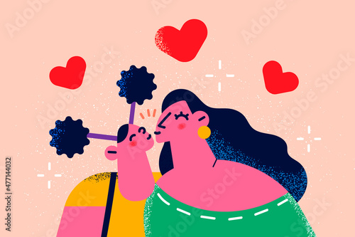 Happy mother and daughter kiss enjoy time together 