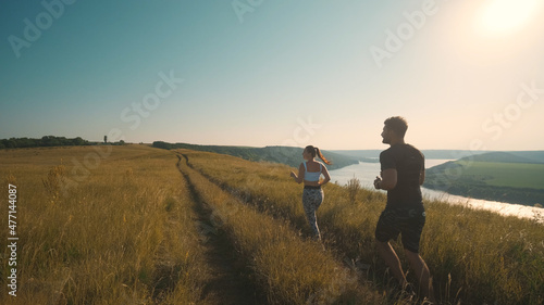 The man and woman running on a beautiful river background