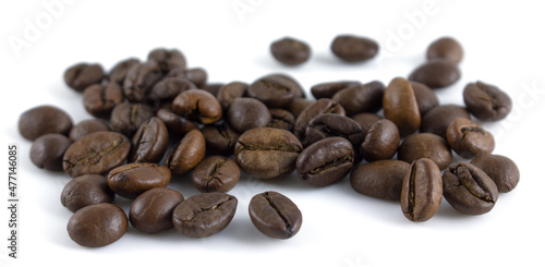 Coffee beans on a white background. Whole roasted arabica grains.