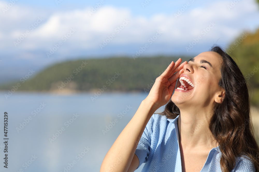 Happy woman screaming in a mountain lake Happy woman screaming in a mountain lake