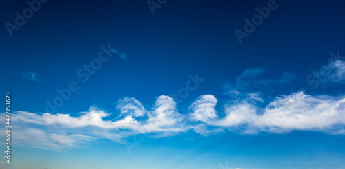 Stratocumulus floccus formation of clouds against blue sky photo
