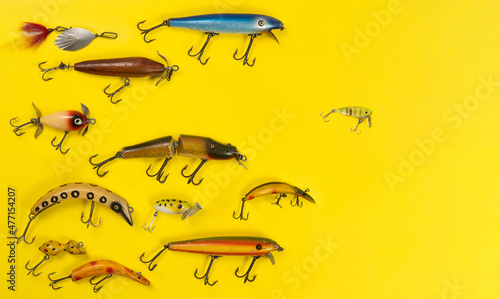 Retro fishing lures against yellow background photo