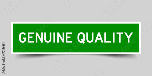 Sticker label with word genuine quality in green color on gray background