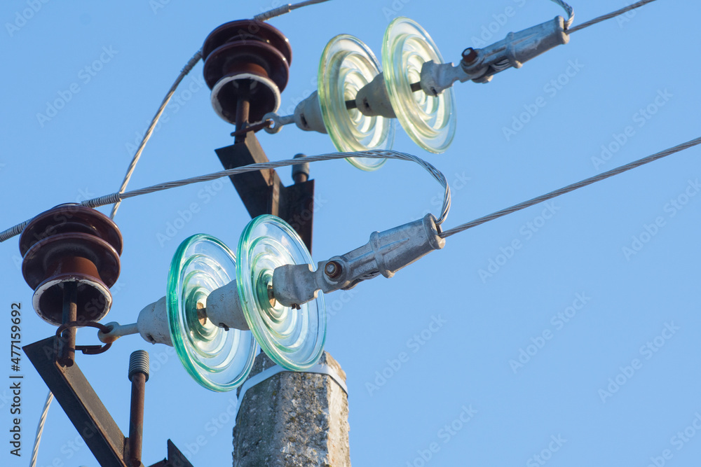 Powerline insulation discs on electric pole. Powerline insulation discs on electric pole.