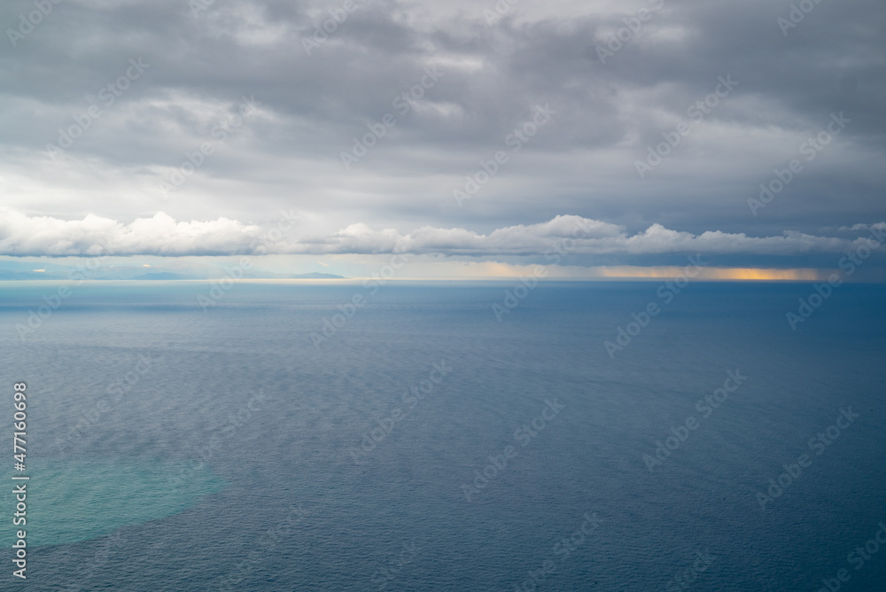 Ocean, sunset, and gray storm clouds offshore, Tyrrhenian Sea, Amalfi Coast, Italy