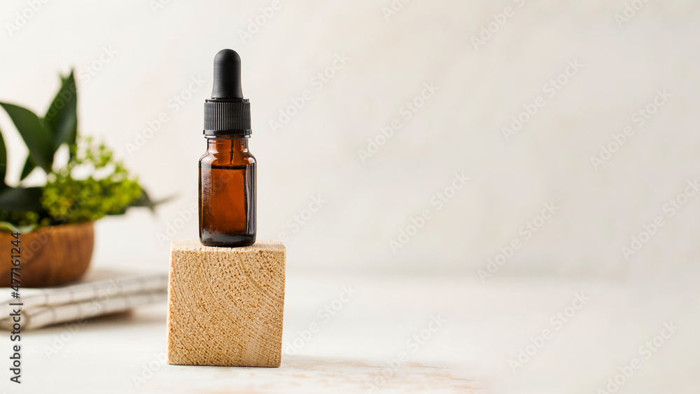 Dropper mockup banner with serum for facial skin care with plants in the background. Copy space. Dropper mockup banner with serum for facial skin care with plants in the background. Copy space.