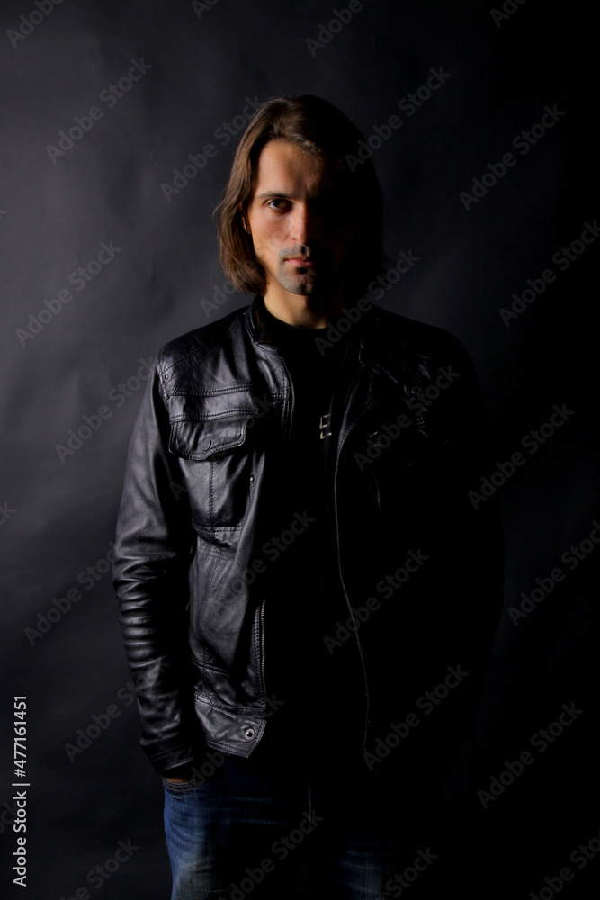 Portrait of a man with shadow on his face on a dark background Portrait of a man with shadow on his face on a dark background