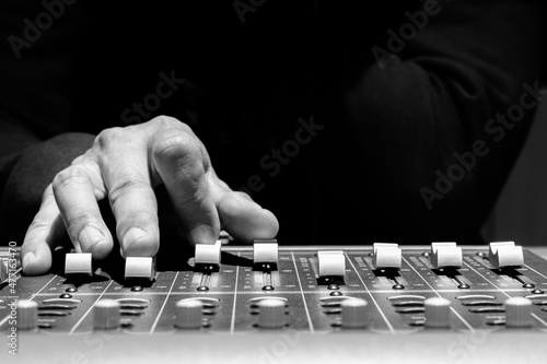 Canvas Print close up sound engineer hands adjusting control surface mixer in recording, broa