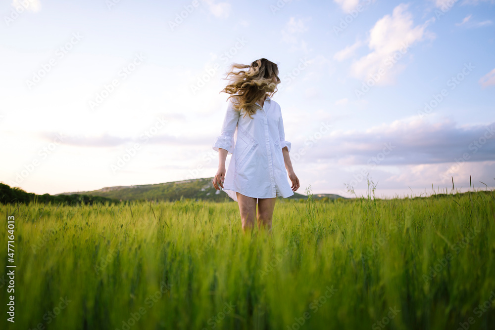Young woman standing in agricultural field Young woman standing in agricultural field
