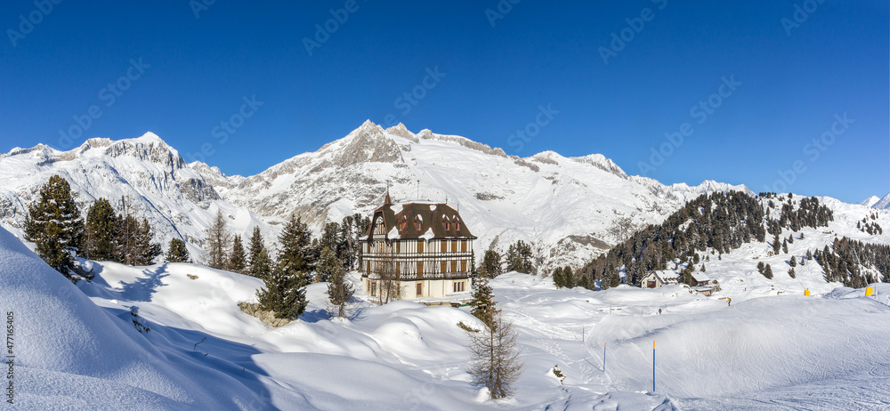 Panorama of the winther landscape of Swiss Alps village Riederalp with the Pro Nature Center Villa Cassel 