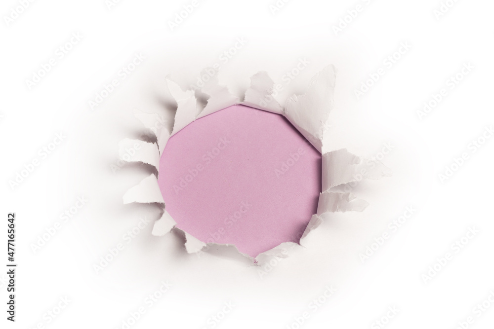 A hole in a white paper on a purple background. A hole in a white paper on a purple background.