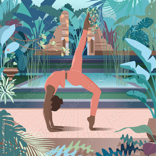 The woman training yoga in the rainforest.