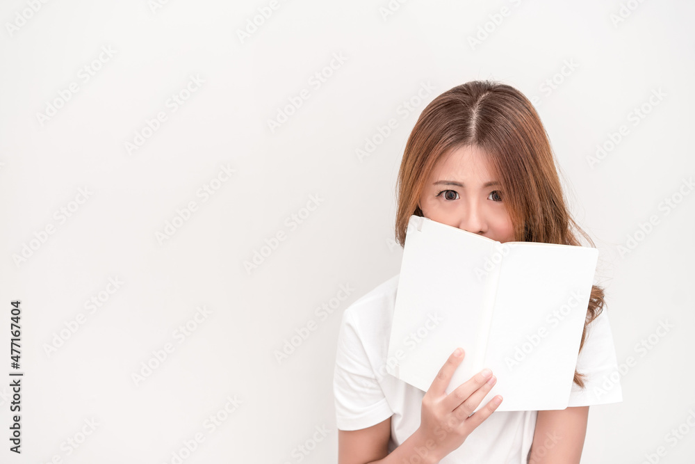 Young attractive asian student holding books in her arm on white background. School girl with a books to read for homework. Young attractive asian student holding books in her arm on white background. School girl with a books to read for homework.