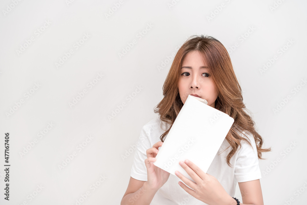 Young attractive asian student holding books in her arm on white background. School girl with a books to read for homework. Young attractive asian student holding books in her arm on white background. School girl with a books to read for homework.