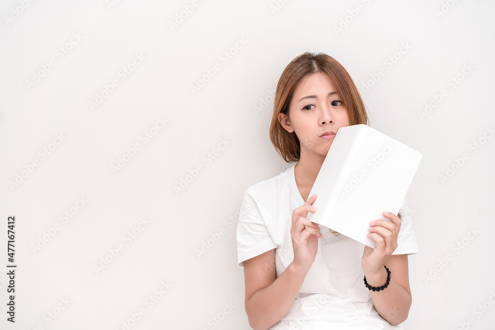 Young attractive asian student holding books in her arm on white background. School girl with a books to read for homework. Young attractive asian student holding books in her arm on white background. School girl with a books to read for homework.