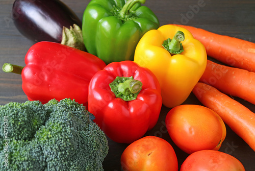 Colorful assorted fresh vegetables on black wooden background or the concept of WELLNESS