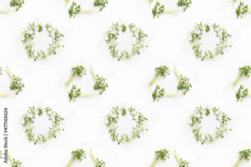 Bunches of microgreens. Flax microgreens on white background. Top view. Seamless repeating pattern.
