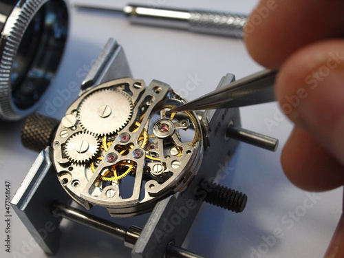 Photos watchmaker repairing vintage mechanical watch mechanism