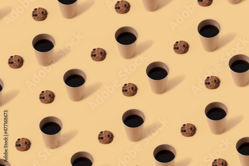 Black coffee in paper cup and chocolate chip cookies on beige background. Seamless repeating pattern.