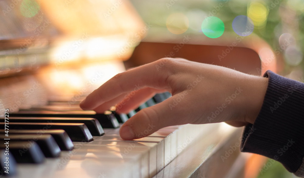 little pianist learning to play the piano on a holiday, horizontal little pianist learning to play the piano on a holiday, horizontal