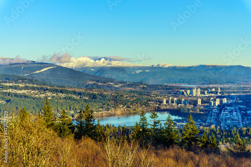 Scenic aerial view of Burrard Inlet at Port Moody, BC, on a clear winter day, with mountain backdrop. © Andrew