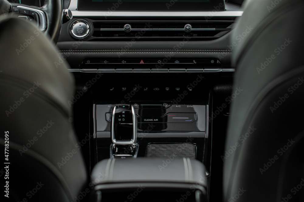 Car interior console close up view. Gear stick with multimedia console. Front view.
