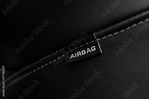 Close up view of airbag label on the side of a car seat. Airbag safety system symbol on the car seat. Modern car interior details.