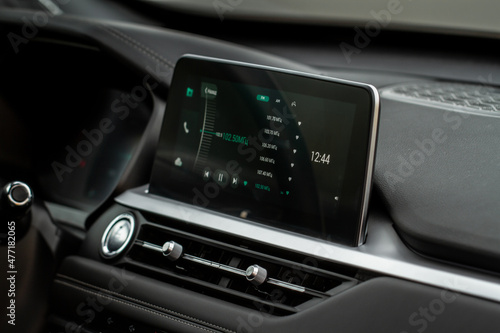Digital car radio. Modern car radio in car. Smart multimedia touchscreen system. © Roman