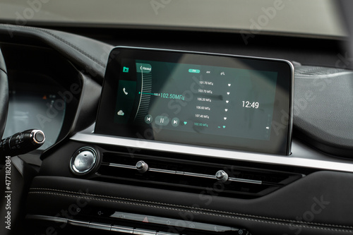 Digital car radio. Modern car radio in car. Smart multimedia touchscreen system.