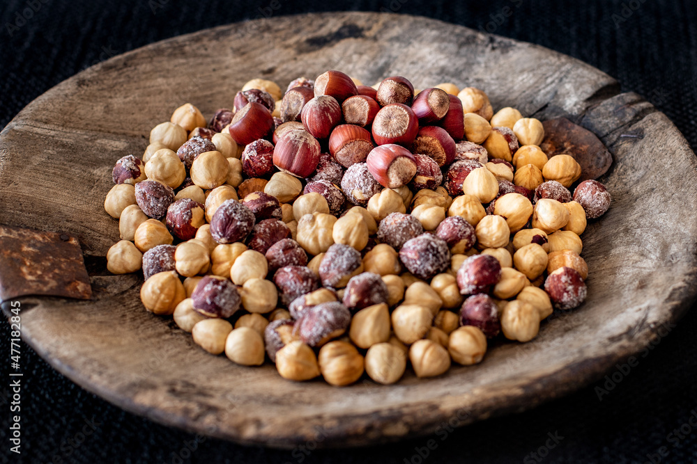 Many hazelnuts in the old rustic wooden bowl Many hazelnuts in the old rustic wooden bowl
