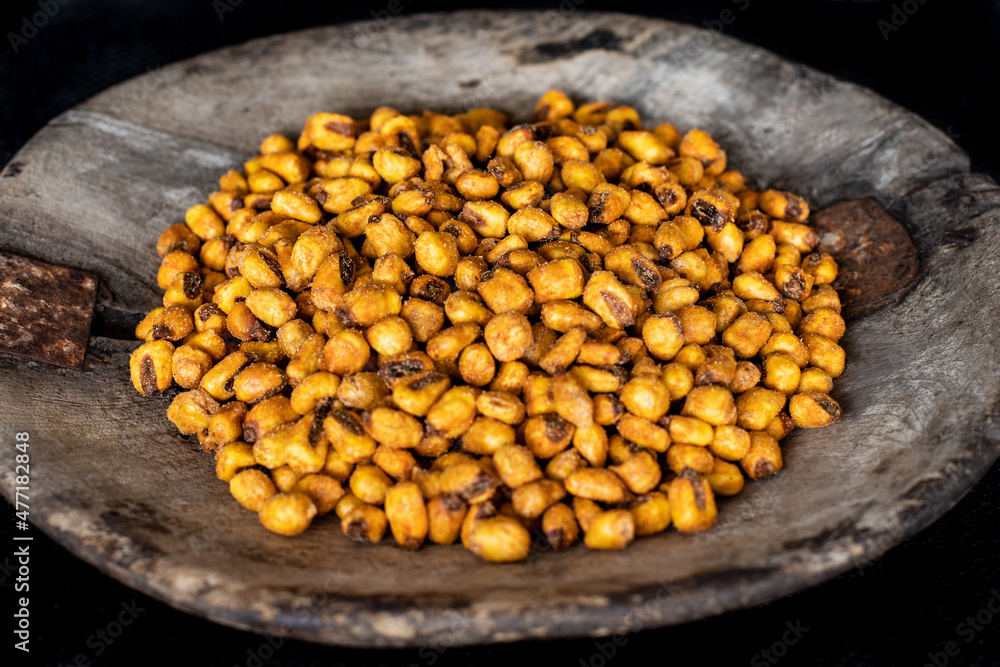 Many corn nuts in the old rustic wooden bowl Many corn nuts in the old rustic wooden bowl