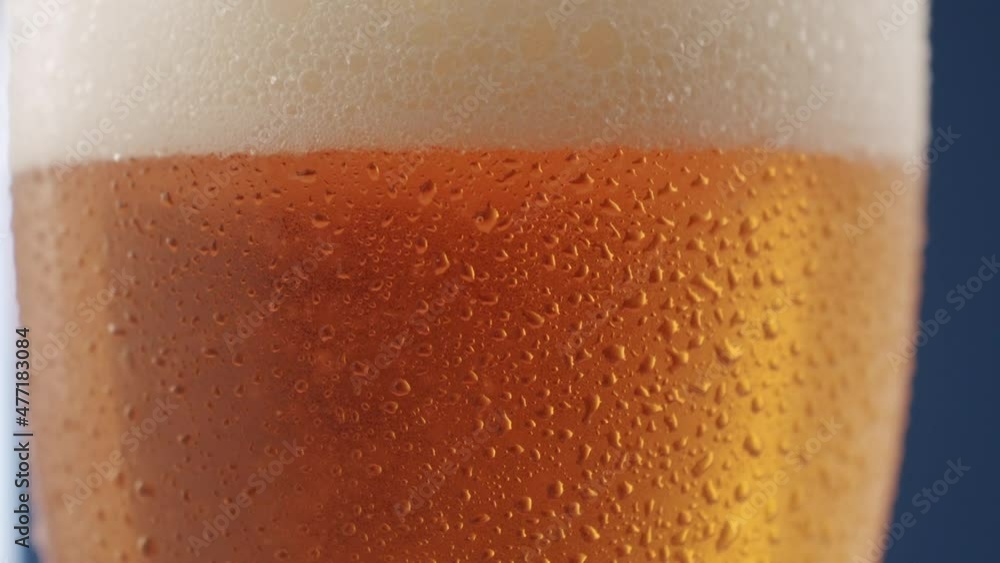 macro shot of beer drink, close-up, with drops on the glass macro shot of beer drink, close-up, with drops on the glass