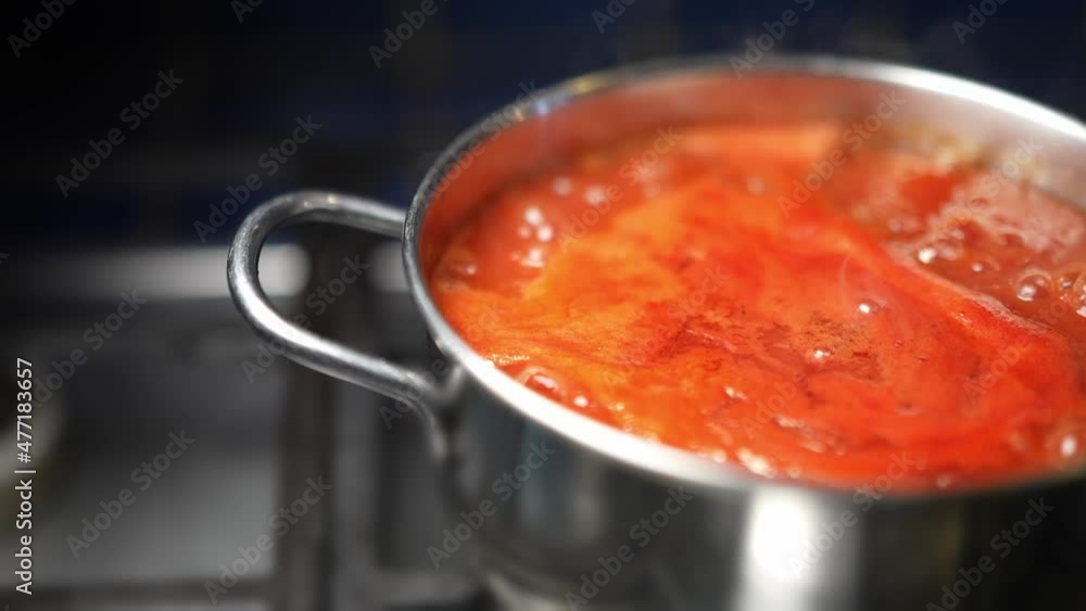 Zoom in of tomato sauce or ketchup boiling in a steel pan. Tasty vegetarian ingredient for a traditional Italian meal. Zoom in of tomato sauce or ketchup boiling in a steel pan. Tasty vegetarian ingredient for a traditional Italian meal.