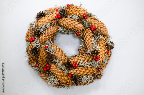 Christmas and New Year wreath of cones as an ecological decoration for the home.
