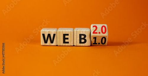 WEB 1.0 or 2.0 symbol. Turned a wooden cube and changed words WEB 1.0 to WEB 2.0. Beautiful orange table, orange background, copy space. Business, technology and WEB 1.0 or 2.0 concept.