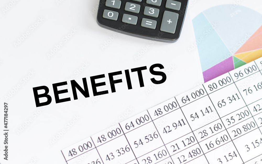 benefits text on notepad next to reports and calculator, business concept benefits text on notepad next to reports and calculator, business concept