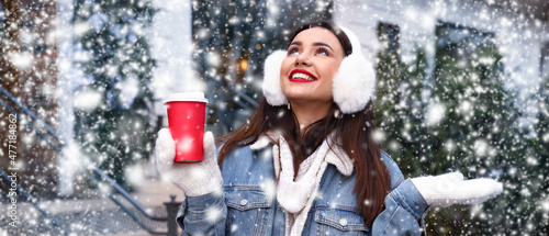 Happy young woman with cup ...
