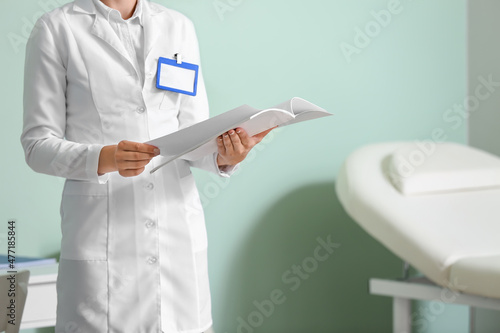 Female doctor with book in medical office