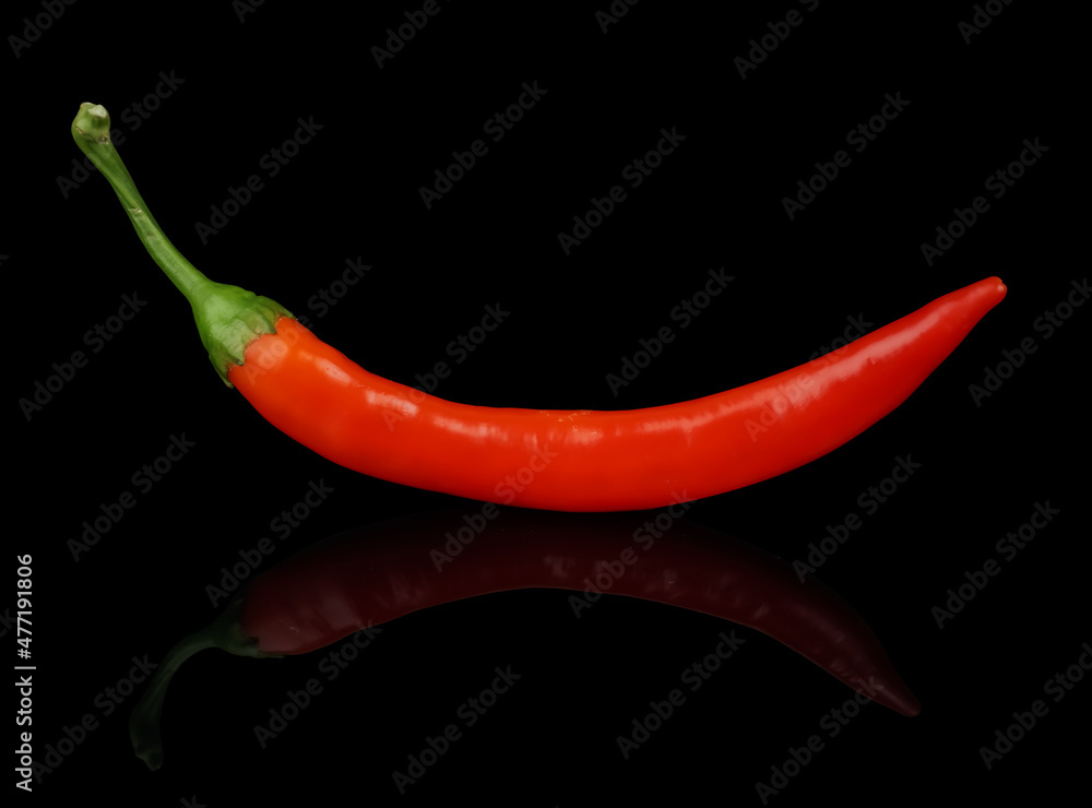 Ripe hot pepper, red on a black background isolated with reflection Ripe hot pepper, red on a black background isolated with reflection