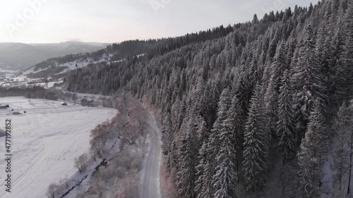 Winter in the mountains. Forest in the snow. Shooting from a quadcopter.