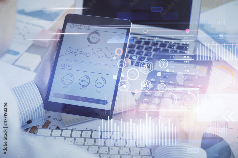 Double exposure of man's hand holding and using a digital device and data theme hologram drawing. Technology concept.